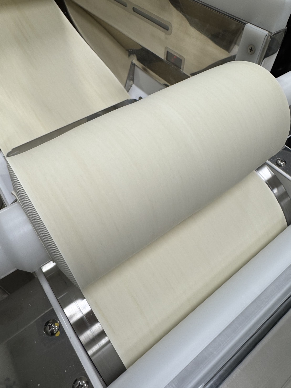 Noodle dough through machine rollers